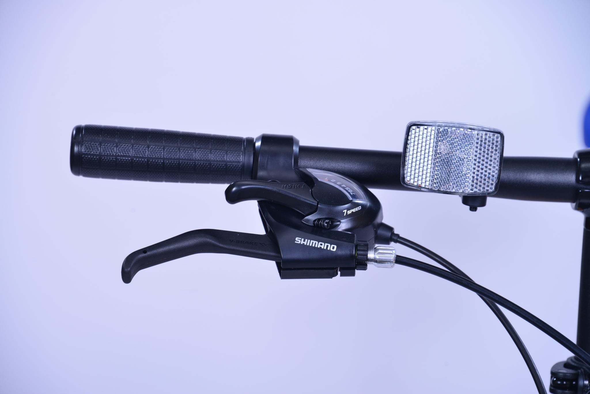 Right handlebar with Shimano gear shift for a bike.