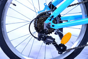 Back wheel and derailleur of a blue and orange folding bicycle.
