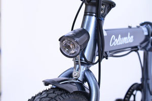 Front light of a gray electric folding bicycle.