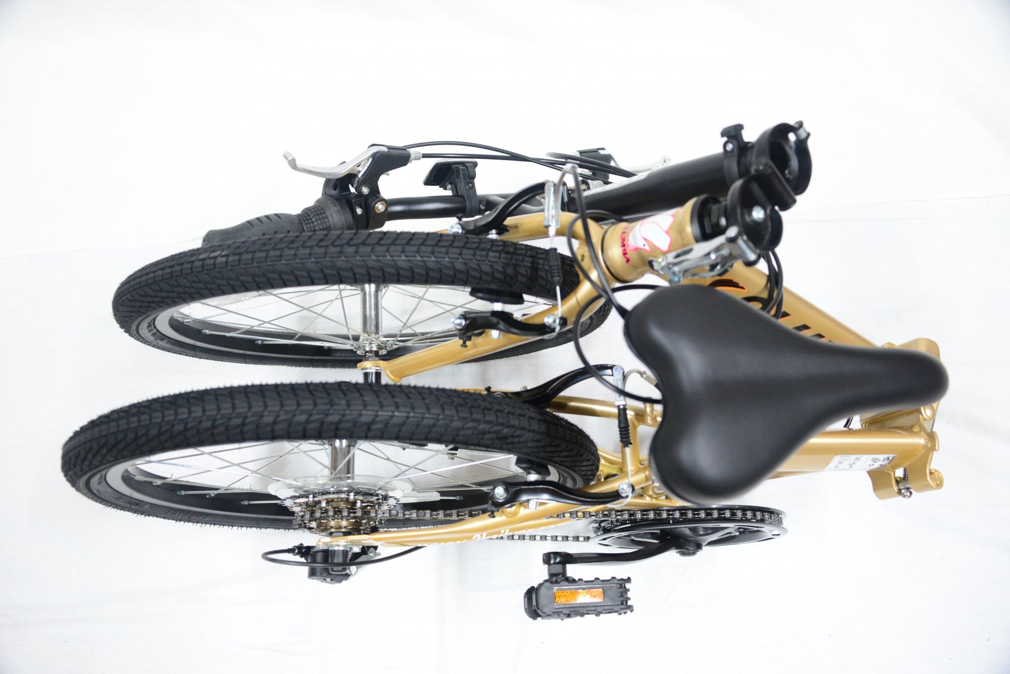Top view of a gold folding bicycle.