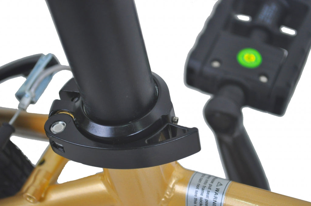 Seatpost insertion part of a gold folding bicycle.