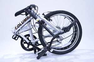 View of the folded position of a silver folding bicycle.