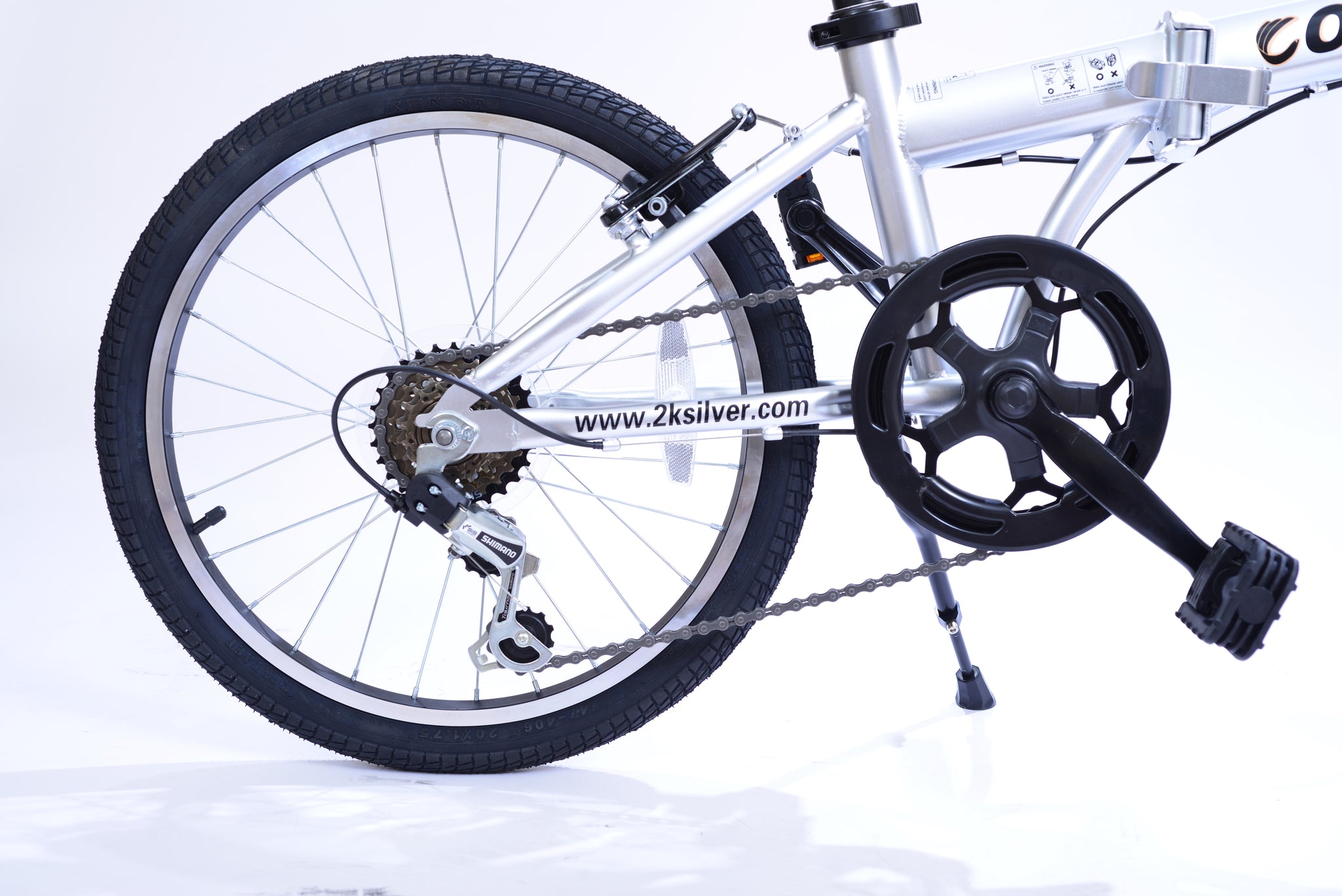 Back wheel of a silver folding bike.