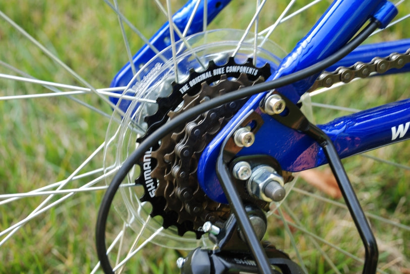 Rear gear on a blue folding bicycle.