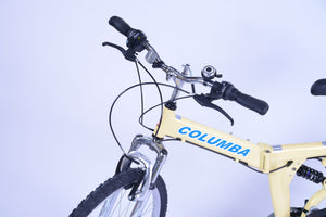 Front view of a cream colored folding bicycle.
