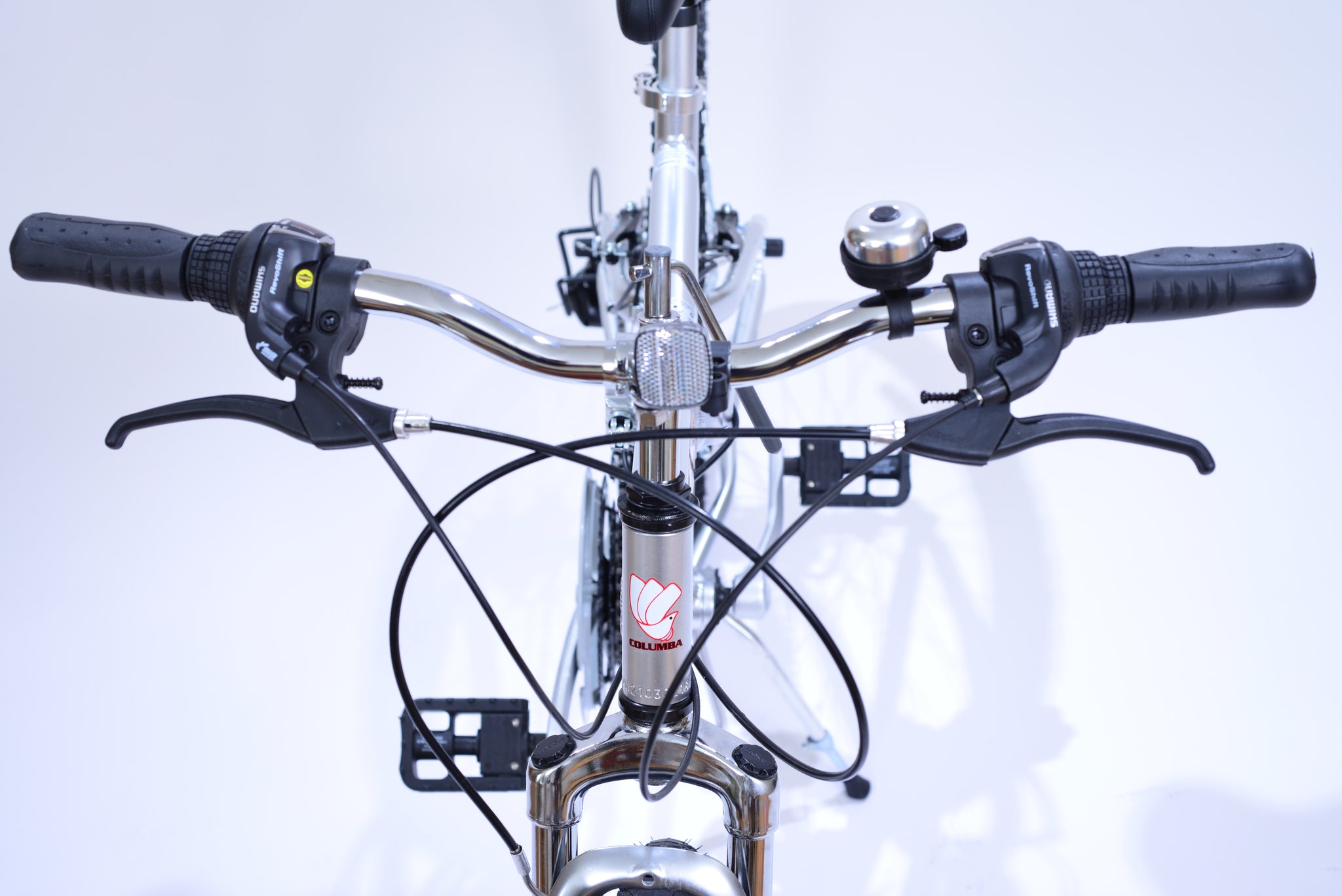 Front handlebar and tube of silver folding bicycle.