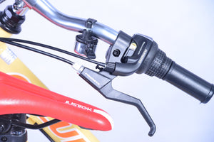 Handle of a bicycle with gear shift and a brake.