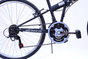 The view of the back wheel, chain ring, and crank arm of a black bicycle.
