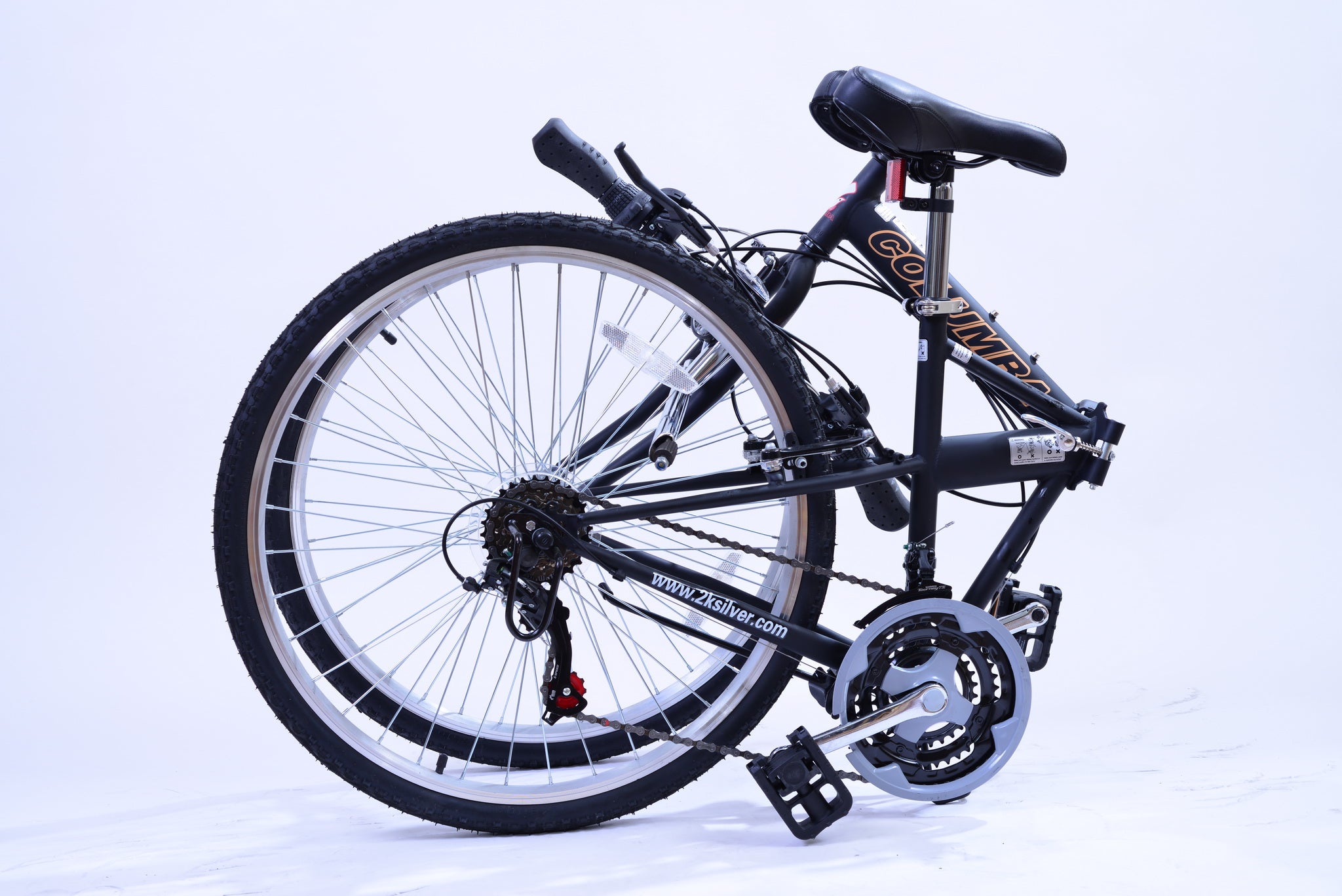 Black bicycle in a folded position sitting on the ground.