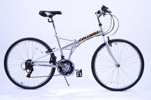 Full view of a silver folding bicycle that reads "Columba" on the tube.